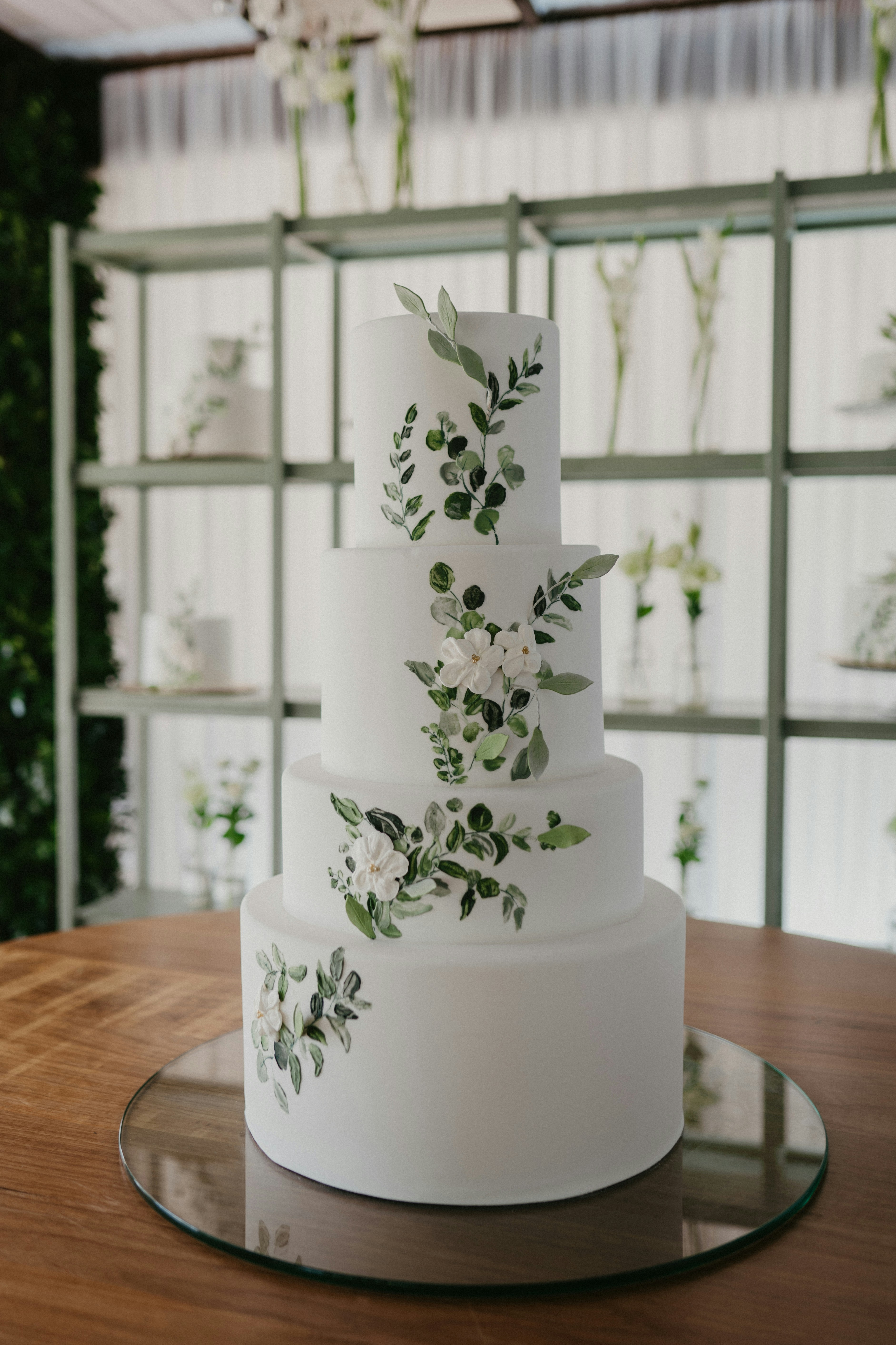 4 tier white wedding cake with flowers